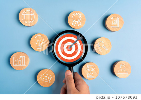 Person holding a magnifying glass focus business growth success achievement concept, customer target group concept. 107678093