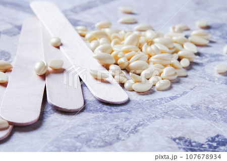 Wax for hair removal. Hair removal with wax. Wax for hair removal. Hair removal with wax. 107678934