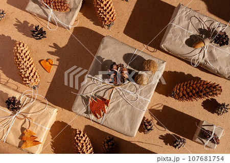 Zero waste Christmas knolling concept flat lay hard shadows. Hand craft eco gift natural New Year decorations top view. Zero waste Christmas knolling concept flat lay hard shadows. Hand craft eco gift natural New Year decorations top view. 107681754