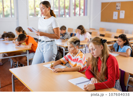 Young girl and boy studying subject in classroom Young girl and boy studying subject in classroom 107684038