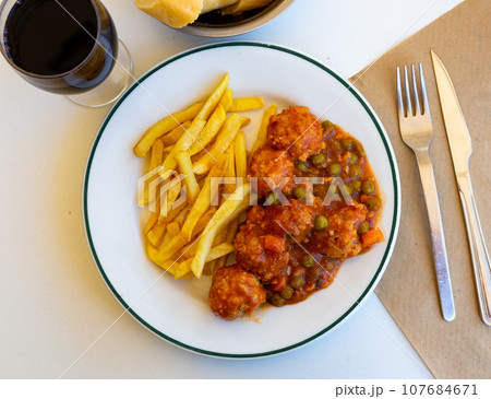 Meatballs and french fries 107684671