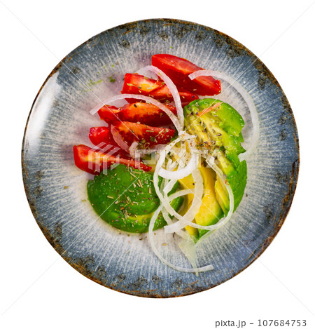 Pieces of avocado, tomato and onion rings served in a plate Pieces of avocado, tomato and onion rings served in a plate 107684753