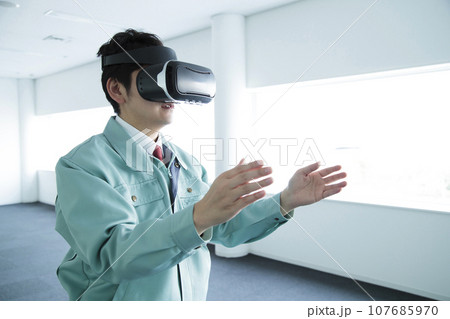 オフィスでVRを見る作業服の若い男性のエンジニア 107685970