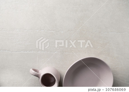 Pottery on a concrete light background Pottery on a concrete light background 107686069
