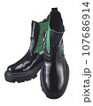 Beautiful pair of high demi-season boots made of glossy black leather with a green elastic band on the sides, with a massive sole, isolated on a white background. 107686914