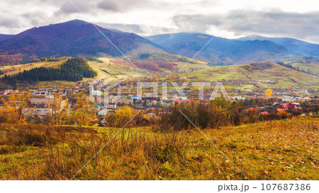 rural landscape in autumn. stunning mountainous countryside scenery with forested hills, valley and open vista rural landscape in autumn. stunning mountainous countryside scenery with forested hills, valley and open vista 107687386