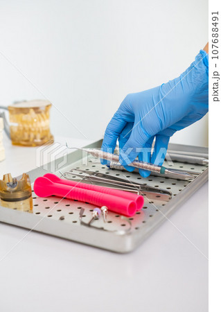 Dentist hook in the hand of doctor in dentist office Dentist hook in the hand of doctor in dentist office 107688491