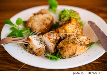 Fried pieces of chicken fillet breaded with spices and herbs in a plate . Fried pieces of chicken fillet breaded with spices and herbs in a plate . 107689139