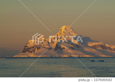 Lemaire strait coastal landscape, mountains and icebergs, Antarctic Peninsula, Antartica. 107690082