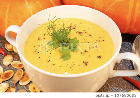 Pumpkin hot puree soup on a wooden table 107690685