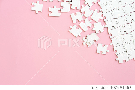 Puzzle pieces on pink background 107691362