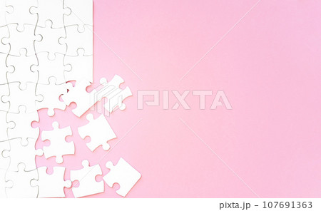 Puzzle pieces on pink background 107691363