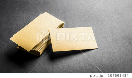 Blank golden business card on grey background 107691434