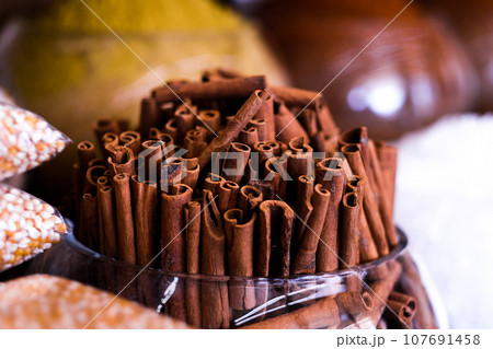 Cinnamon sticks in glass vase Cinnamon sticks in glass vase 107691458