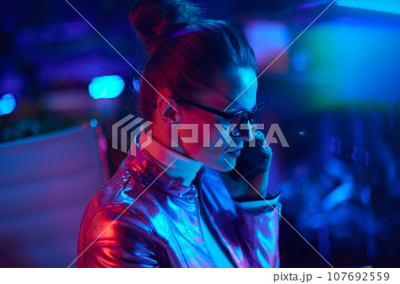 elegant business woman in glasses talking on smartphone 107692559