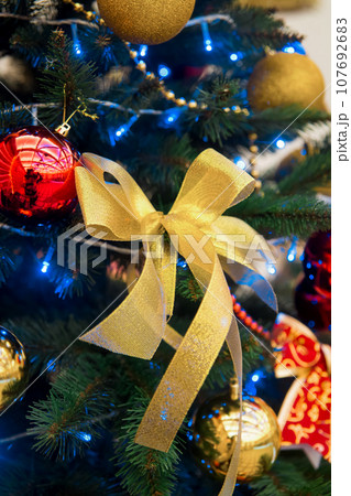 New Year's bow decoration of a green Christmas tree holiday details objects toys celebration 107692683