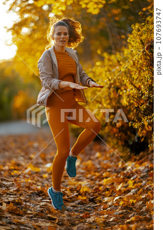 modern female in fitness clothes in park workout modern female in fitness clothes in park workout 107693747
