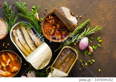 Open tin cans with canned fish 107694102