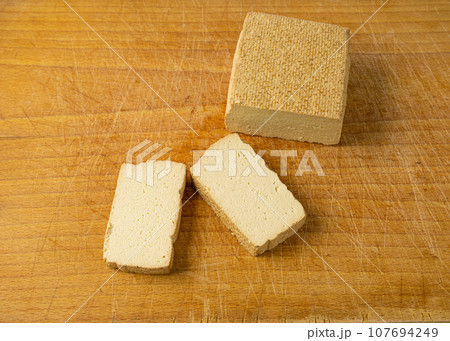 Tofu Cheese Isolated, Smoked Vegan Cheese Slice, Sliced Soya Bean Curd, Soy Protein or TSP Tofu Cheese Isolated, Smoked Vegan Cheese Slice, Sliced Soya Bean Curd, Soy Protein or TSP 107694249