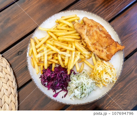 Traditional Polish Chop, Breaded Cutlet, Roasted Pork Steak in Breadcrumbs with Fresh Cabbage Salads Traditional Polish Chop, Breaded Cutlet, Roasted Pork Steak in Breadcrumbs with Fresh Cabbage Salads 107694796