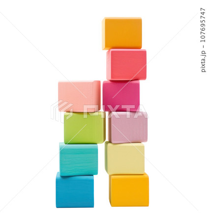 Colorful blocks stacked high in a tower, ready to topple isolated Colorful blocks stacked high in a tower, ready to topple isolated 107695747