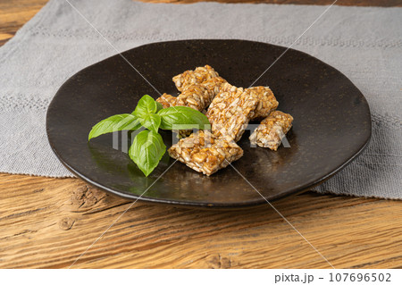 Sunflower Seeds Bar on Black Plate, Energy Snack with Honey, Sun Flower Seed Muesli Dessert Sunflower Seeds Bar on Black Plate, Energy Snack with Honey, Sun Flower Seed Muesli Dessert 107696502