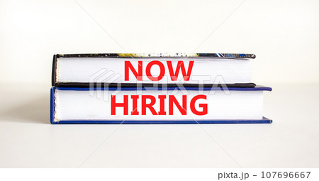 Now hiring symbol. Concept words Now hiring on beautiful books. Beautiful white table white background. Business marketing, motivational now hiring concept. Copy space. 107696667