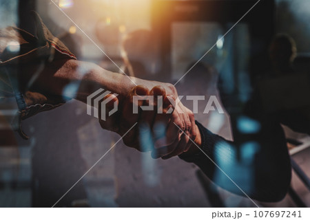 Handshaking of business people in office as concept of teamwork and partnership 107697241