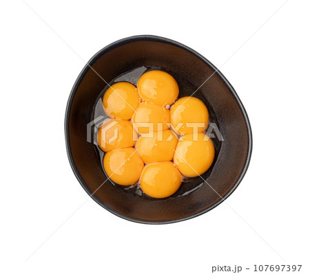 Egg Yolks in Bowl, Fresh Chicken Egg Yolk Separated from Whites for Cooking Recipe, Organic Yolks Top View 107697397