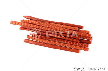 Fish Jerky Isolated, Dry Salted Seafood Snack, Hake Stockfish, Small Pieces of Dehydrated Pollock Fish Jerky Isolated, Dry Salted Seafood Snack, Hake Stockfish, Small Pieces of Dehydrated Pollock 107697434