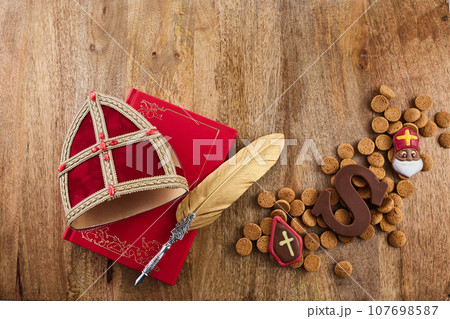 Dutch holiday Sinterklaas background with mitre or mijter staff and book of Sinterklaas. 107698587