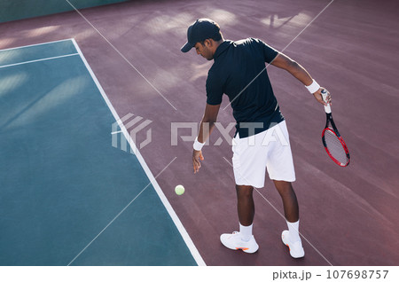 Professional tennis player on a hard court before serve	 107698757