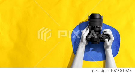 Person holding a SLR camera Person holding a SLR camera 107701928