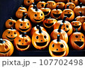 Orange pumpkin with a scary face wearing a black witch hat on Halloween. 107702498