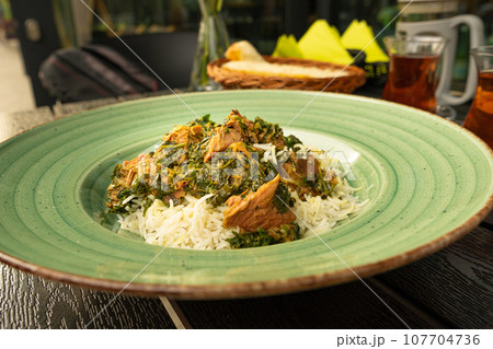 Pilau on Green Plate, Beef Pilaf, Traditional Asian Dish Plov also known as Polow, Pilav, Pallao, Pulao, Palaw 107704736
