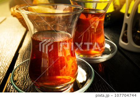 Turkish Tea on a Street Cafe Table, Arabic Cup in Restaurant, Black Tea Drinking in Turkish Cup 107704744