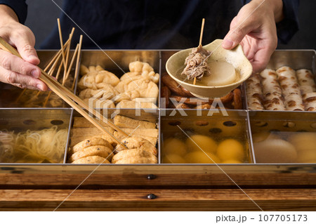 熱々のおでんを箸ですくう料理人 熱々のおでんを箸ですくう料理人 107705173