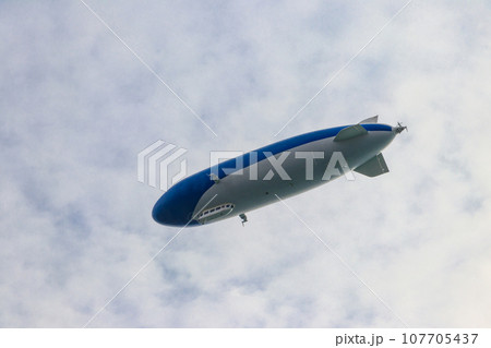 Blimp, airship or dirigible flying in sky Blimp, airship or dirigible flying in sky 107705437