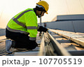 Engineer worker working at solar cell power plant with sunset 107705519