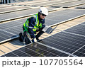 Engineers with safety helmet checking solar system at solar power farm 107705564