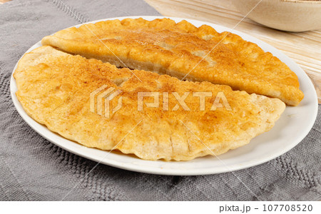 Deep-Fried Flat Pie. Turnover with Filling of Ground Meat and Onions, Stuffed Chebureki, Deep-Fried Flat Pie. Turnover with Filling of Ground Meat and Onions, Stuffed Chebureki, 107708520