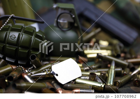 Different types of ammunition on a camouflage background. Preparing for war Different types of ammunition on a camouflage background. Preparing for war 107708962