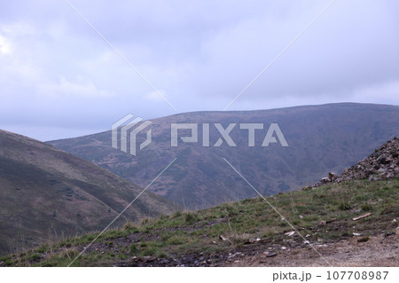 Morning view from the Dragobrat mountain peaks in Carpathian mountains, Ukraine. Cloudy and foggy landscape around Drahobrat Peaks Morning view from the Dragobrat mountain peaks in Carpathian mountains, Ukraine. Cloudy and foggy landscape around Drahobrat Peaks 107708987