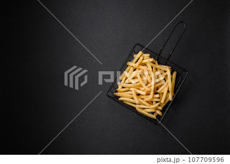 Fresh delicious crispy French fries with salt and spices 107709596