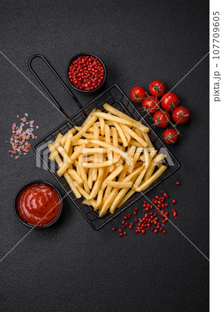 Fresh delicious crispy French fries with salt and spices 107709605