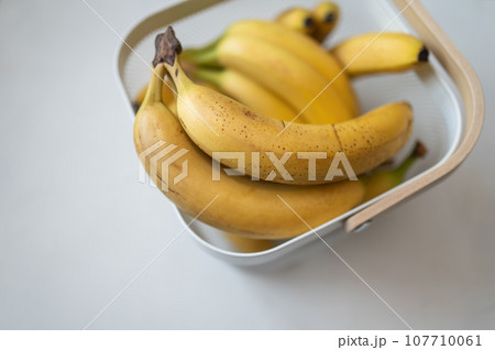 Ripe yellow fruit bananas in decorative bag. White background. Top view. Tropical sweet food 107710061