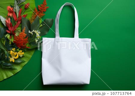 White tote bag mockup on green background. Shopper handbag. Template blank cotton shopping eco reusable bag. Green Friday, sale accessories. Minimalist eco friendly design, zero waste movement concept White tote bag mockup on green background. Shopper handbag. Template blank cotton shopping eco reusable bag. Green Friday, sale accessories. Minimalist eco friendly design, zero waste movement concept 107713764
