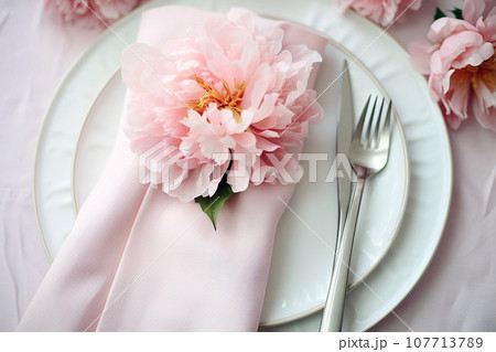Beautiful table setting with flower decorations. Dishware, silverware and decorations on festive table, dinner table prepared for wedding or party, home table decoration Beautiful table setting with flower decorations. Dishware, silverware and decorations on festive table, dinner table prepared for wedding or party, home table decoration 107713789