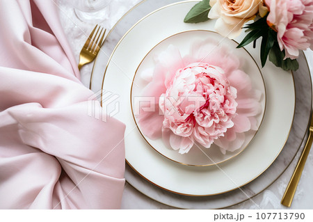 Beautiful table setting with flower decorations. Dishware, silverware and decorations on festive table, dinner table prepared for wedding or party, home table decoration Beautiful table setting with flower decorations. Dishware, silverware and decorations on festive table, dinner table prepared for wedding or party, home table decoration 107713790