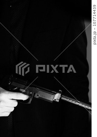 Elegant man holding gun Elegant man holding gun 107714439
